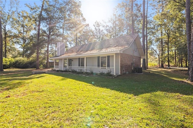 exterior space featuring a lawn, central AC, and covered porch