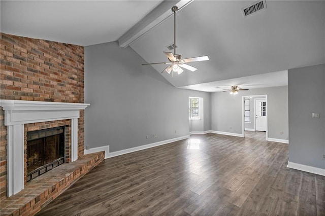 unfurnished living room featuring vaulted ceiling with beams, a brick fireplace, ceiling fan, and dark wood-type flooring