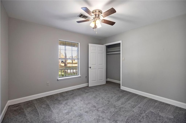 unfurnished bedroom featuring ceiling fan, a closet, and carpet floors