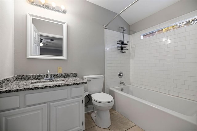 full bathroom featuring ceiling fan, tiled shower / bath combo, tile patterned floors, toilet, and vanity