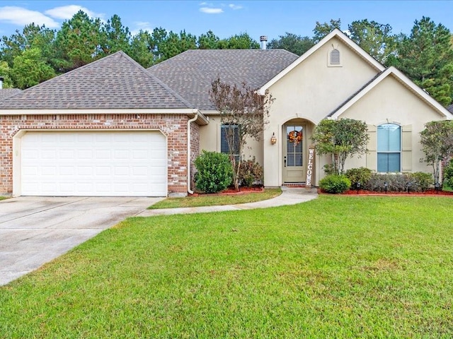 view of front of house with a front yard and a garage