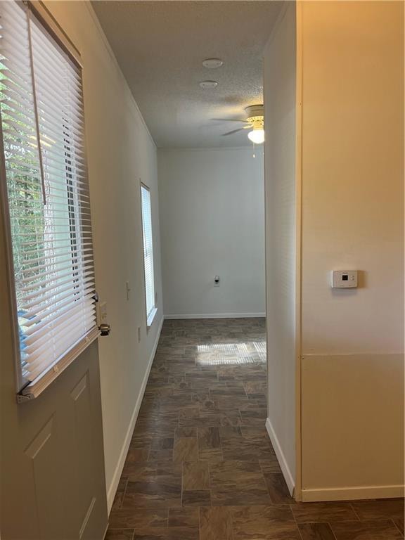 hallway featuring a textured ceiling