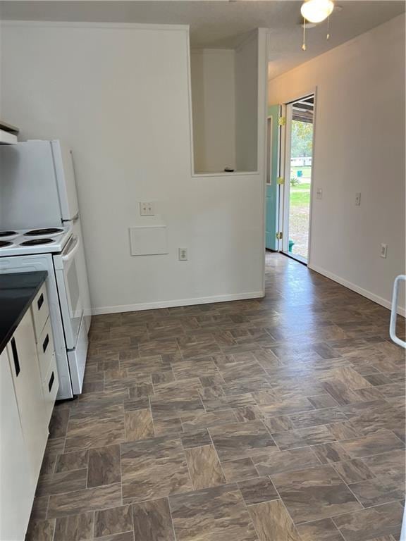 kitchen featuring white cabinetry, ceiling fan, and white appliances