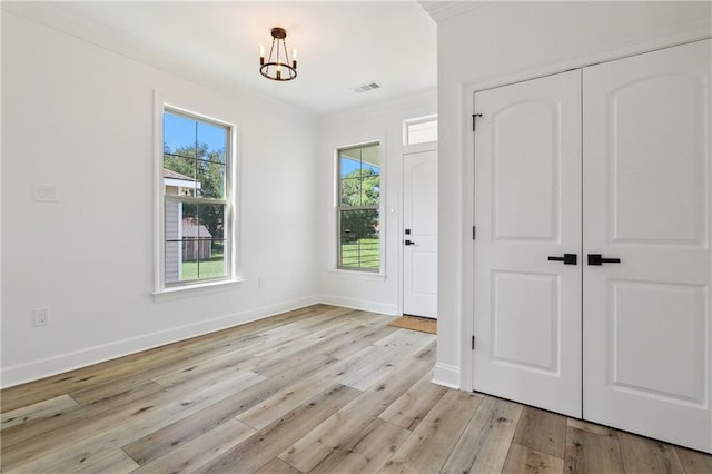 foyer with a chandelier and light wood-type flooring