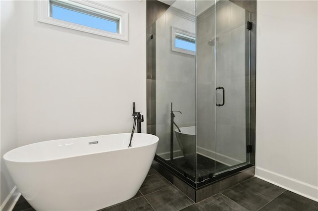 bathroom with plus walk in shower, tile patterned floors, and a healthy amount of sunlight