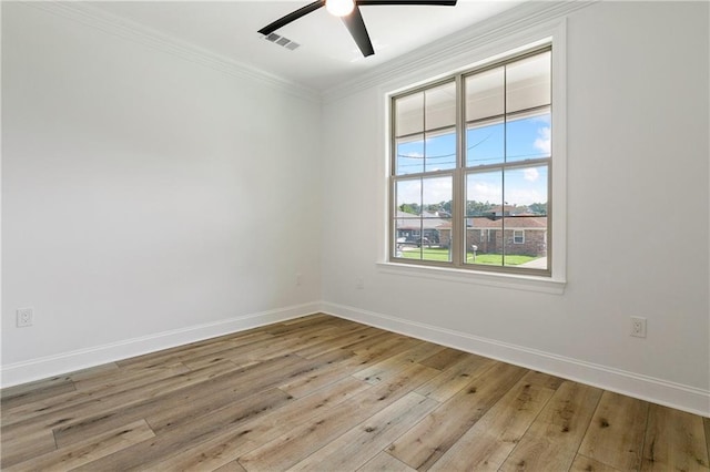 empty room with ceiling fan, light hardwood / wood-style floors, and crown molding