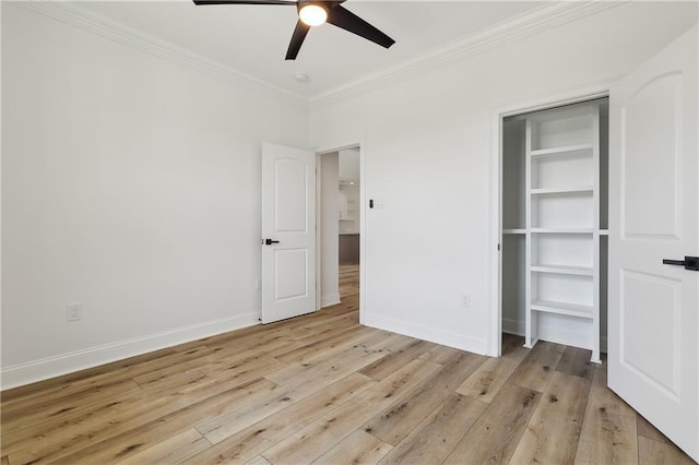 unfurnished bedroom with ceiling fan, light wood-type flooring, crown molding, and a closet