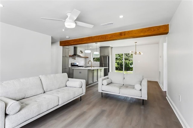 living room with beam ceiling, sink, dark wood-type flooring, and ceiling fan with notable chandelier