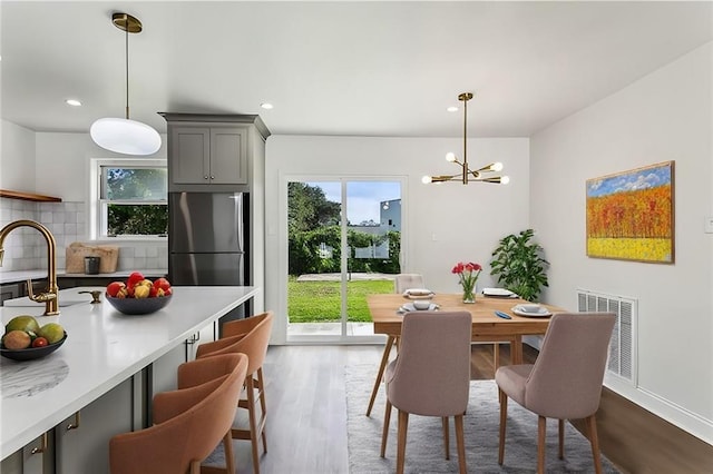 dining area featuring a notable chandelier and hardwood / wood-style flooring