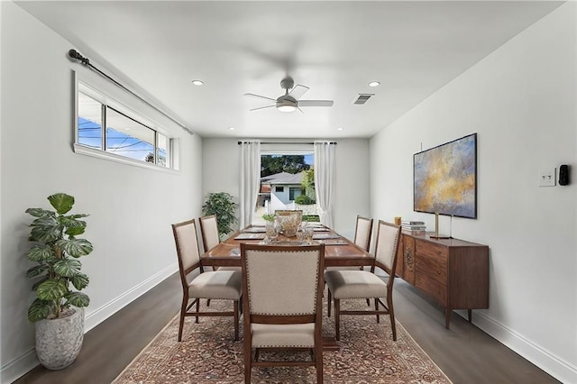 dining area with ceiling fan and dark wood-type flooring