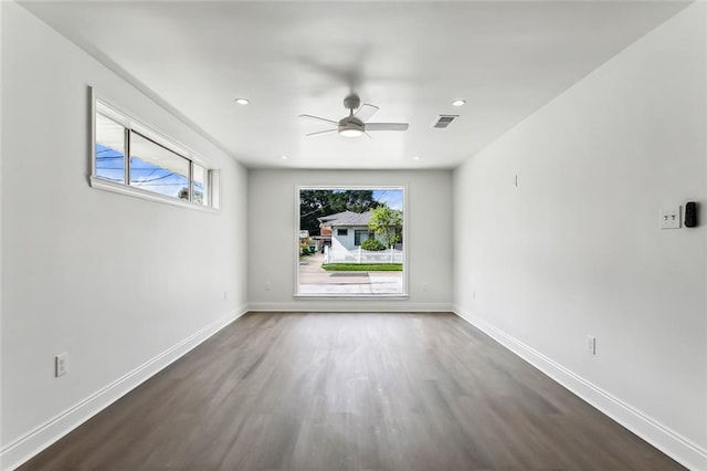 unfurnished room featuring hardwood / wood-style flooring, a wealth of natural light, and ceiling fan