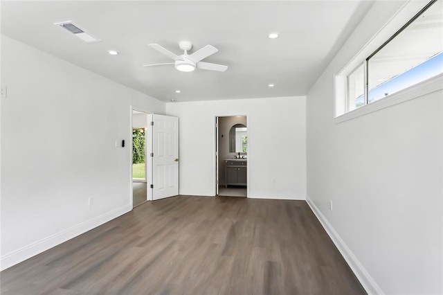 unfurnished room with ceiling fan and dark hardwood / wood-style flooring