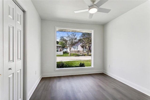 unfurnished dining area featuring ceiling fan and dark hardwood / wood-style flooring