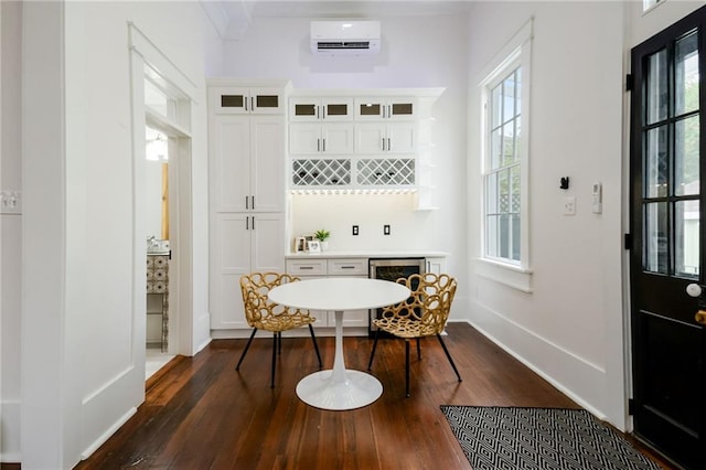 dining room featuring a wall unit AC and dark hardwood / wood-style floors