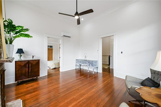 living room with a high ceiling, ceiling fan, dark hardwood / wood-style flooring, and a wall unit AC