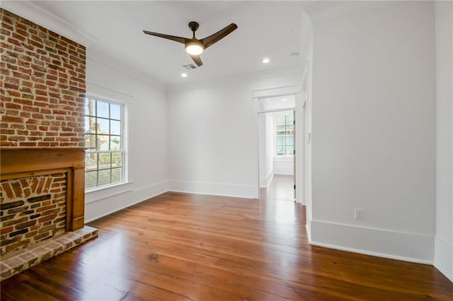 unfurnished living room with a fireplace, hardwood / wood-style flooring, and ceiling fan