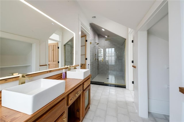 bathroom featuring vanity and an enclosed shower