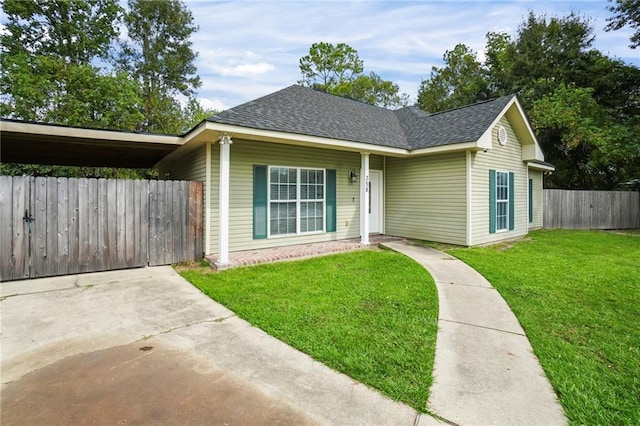 view of front of property with fence, a shingled roof, and a front lawn