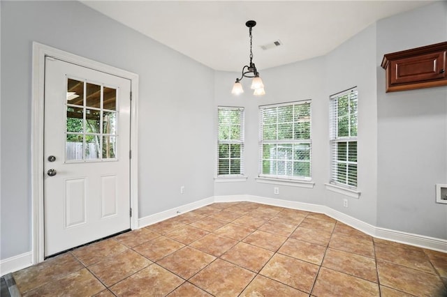 unfurnished dining area featuring visible vents, baseboards, a notable chandelier, and light tile patterned flooring
