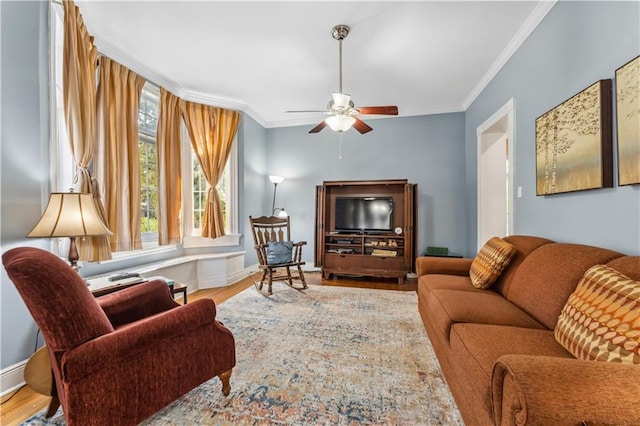 living room with ornamental molding, hardwood / wood-style floors, and ceiling fan