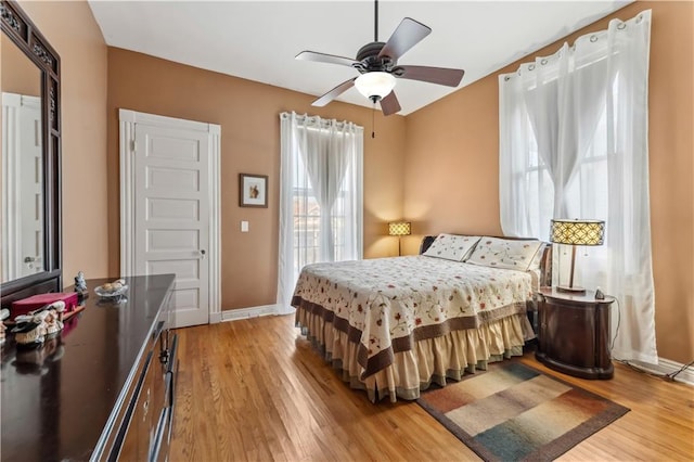 bedroom with light wood-type flooring and ceiling fan