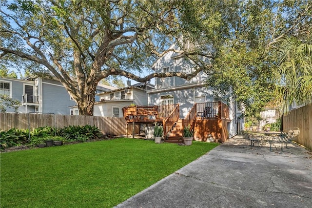 view of yard featuring a patio and a deck