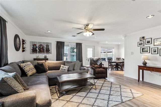 living area featuring light wood-style flooring, crown molding, visible vents, ceiling fan, and recessed lighting