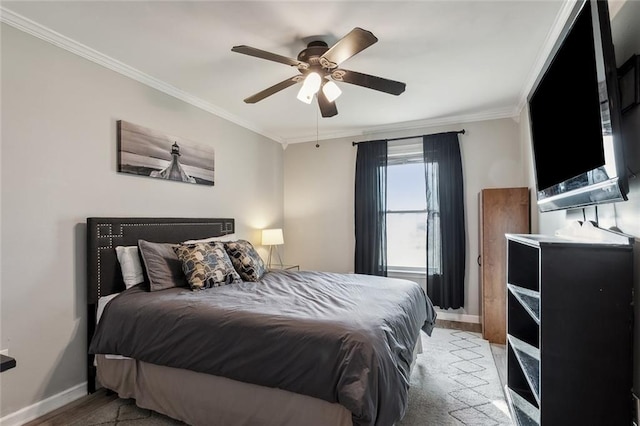 bedroom featuring baseboards, ceiling fan, light wood-type flooring, and crown molding