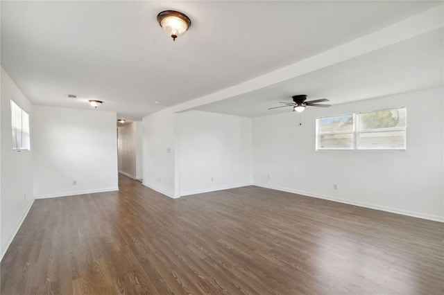 empty room with dark wood-type flooring and ceiling fan