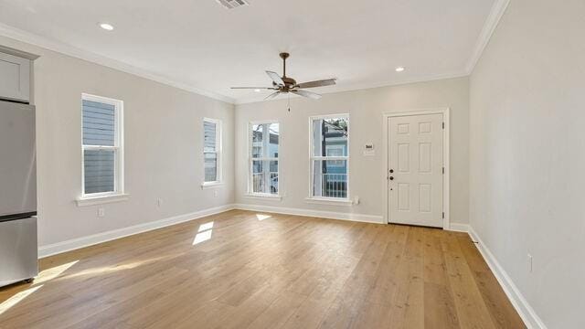 interior space with crown molding, light hardwood / wood-style flooring, and ceiling fan