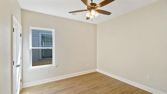 empty room with light hardwood / wood-style floors and ceiling fan