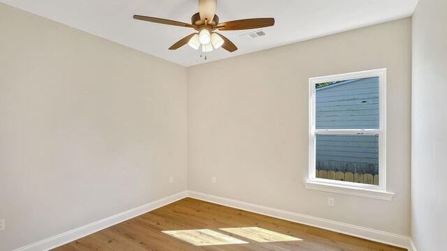 empty room featuring ceiling fan and wood-type flooring