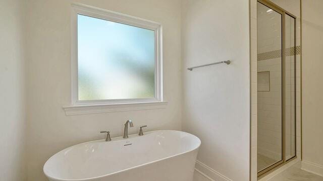 bathroom with sink and plus walk in shower