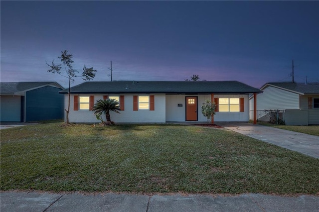 ranch-style home with a yard and a garage