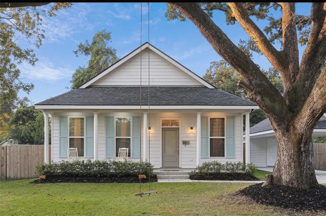 bungalow featuring a front yard and covered porch