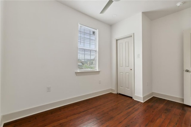 unfurnished bedroom with dark wood-type flooring, a closet, and ceiling fan