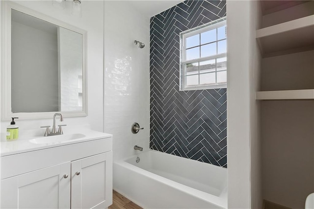 bathroom with vanity, tiled shower / bath combo, and hardwood / wood-style floors