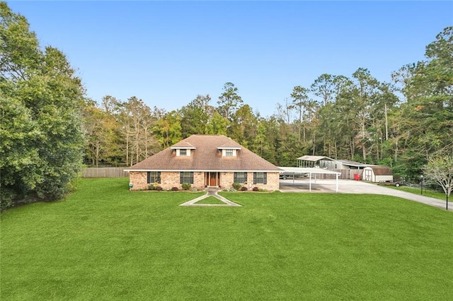 rear view of house with a lawn and a carport