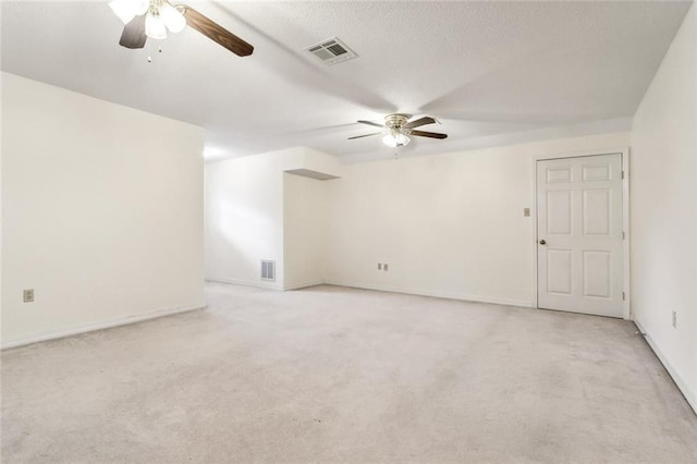 spare room with light colored carpet and ceiling fan