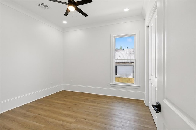 spare room with hardwood / wood-style flooring, ceiling fan, and crown molding