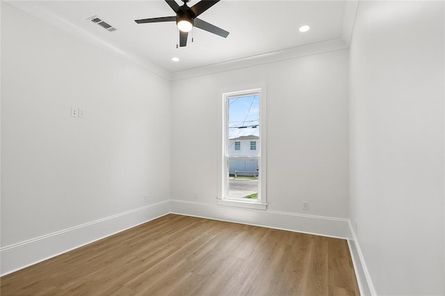 spare room featuring hardwood / wood-style floors, ceiling fan, and ornamental molding