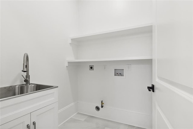 clothes washing area with cabinets, washer hookup, hookup for an electric dryer, sink, and hookup for a gas dryer