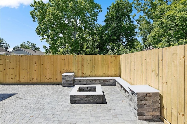 view of patio / terrace featuring an outdoor fire pit