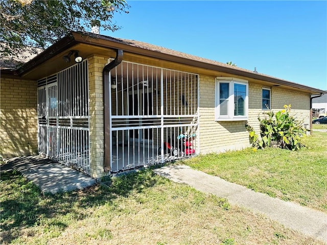 view of side of home with a lawn