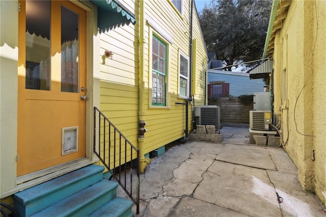 view of side of property featuring a patio area and central AC unit