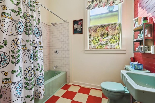 full bathroom with toilet, shower / bathtub combination with curtain, and sink