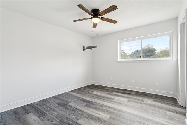 empty room featuring dark hardwood / wood-style floors and ceiling fan