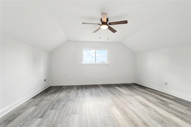 additional living space with ceiling fan, lofted ceiling, and light hardwood / wood-style flooring