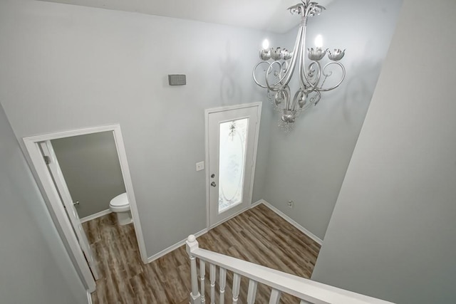 entrance foyer featuring hardwood / wood-style flooring and a notable chandelier