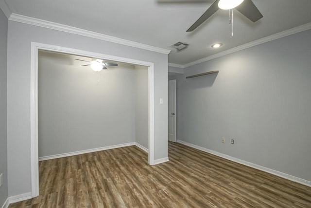 interior space with a closet, ceiling fan, dark hardwood / wood-style flooring, and ornamental molding